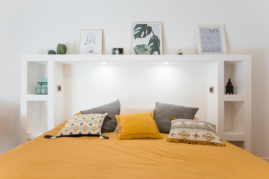 Double bed with built-in headboard shelving and reading lights